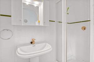 a white bathroom with a sink and a shower at Amor Supremo in Cumbre del Sol +18 photos