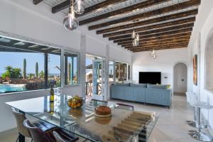a living room with a table and a couch at Villa Dafmir in Tías