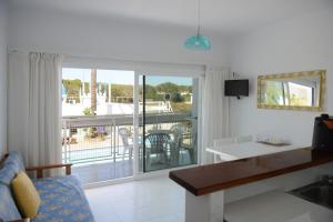 a living room with a view of a balcony at Apartamento Ciel Azul in Santa Eularia des Riu