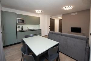 a living room with a table and a couch at Appartamenti Suly 5 - Cir 0086 in Saint Vincent +2 photos