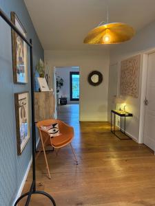 a living room with a table and a chair at 180qm Penthouse mit Sonnenterrasse in Rostock