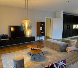 a living room with a couch and two tables at 180qm Penthouse mit Sonnenterrasse in Rostock