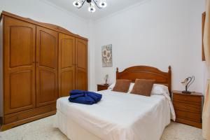 a bedroom with a bed and a large wooden cabinet at Casa Abuela Maruca in Corralejo
