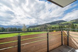 a balcony with a fence and a view of mountains at Waldheim in Verano