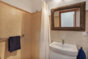 a bathroom with a sink and a mirror at Casa Abuela Maruca in Corralejo +23 photos