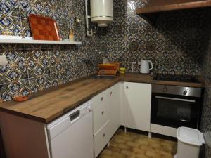 a kitchen with a counter top and a stove at Casa Da Azenha in Baião +17 photos