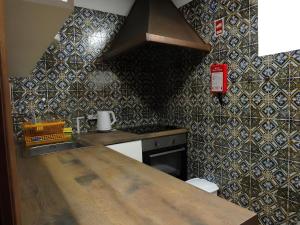 a kitchen with a counter top and a stove at Casa Da Azenha in Baião