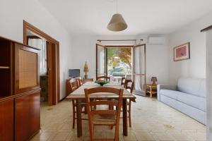 a living room with a table and a couch at Hause Sant'Ilario in Campo nell'Elba