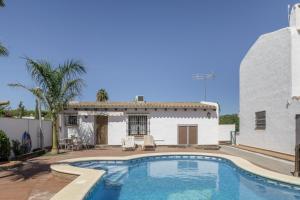a swimming pool in front of a house at Cortijo Entrepinares in Conil de la Frontera