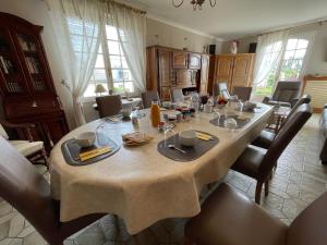 a large dining room table with chairs and a table cloth at La Mansardière in Cancale