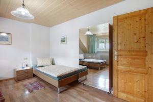 a bedroom with a bed and a door to a room at Ferienwohnung Hildegard in Rappersweier