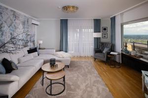 a living room with a couch and a table at Baden-Chalet - Panoramablick in Bühl