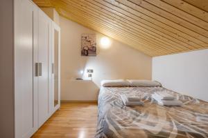 a bedroom with a bed and a wooden ceiling at The Maisonette Sierra Nevada in Monachil