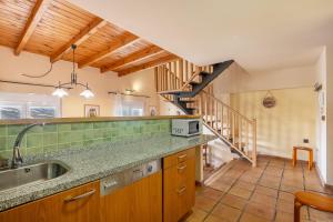 a kitchen with a sink and a staircase at The Maisonette Sierra Nevada in Monachil