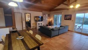 a living room with a couch and a table at Le Gite De La Colline in Nérac