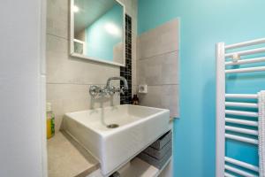a bathroom with a sink and a mirror at Petite Maison Malestroyenne in Malestroit +11 photos