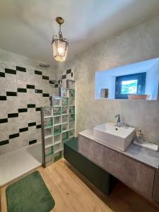 a bathroom with a sink and a shower at L’Angelina in Martrin +15 photos