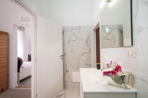 a bathroom with a sink and a mirror at Suite Biancolino in Nardò