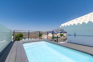 a swimming pool on the roof of a house at Stunning apartment in Cómpeta in Cómpeta
