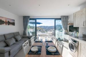 a kitchen and living room with a couch and a table at Stunning apartment in Cómpeta in Cómpeta