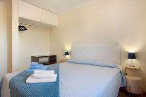 a bedroom with a bed with towels on it at Levada Residence in Funchal