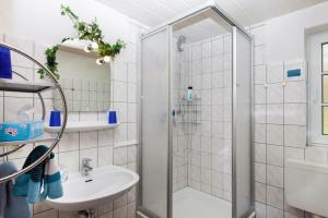 a bathroom with a shower and a sink at Dat Möhlenhus Peter Jensen in Pellworm +48 photos