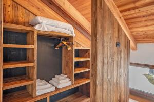 a room with bunk beds in a wooden cabin at Lòni Lodge Vermiglio in Vermiglio +141 photos