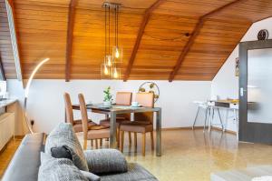 a living room with a table and a couch at Fewo Naturblick in Wiesenthau