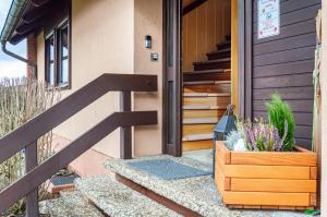 a house with a wooden door and a potted plant at Fewo Naturblick in Wiesenthau