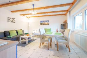 a living room with a table and chairs and a couch at Ferienwohnung Martin Lehmann in Oberharmersbach +22 photos