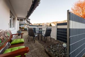 a patio with chairs and a table and a fence at Ferienwohnung Martin Lehmann in Oberharmersbach