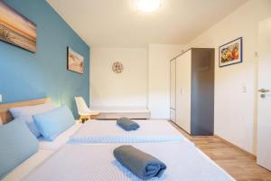 a bedroom with two beds and a closet at Ferienwohnung Martin Lehmann in Oberharmersbach