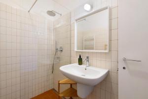 a white bathroom with a sink and a mirror at U Canetta 1 in Pietra Ligure
