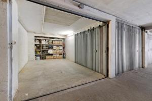 an empty room with a door leading into a garage at U Canetta 1 in Pietra Ligure