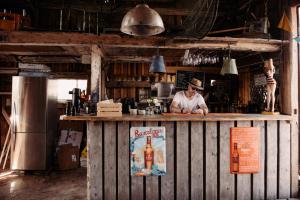 a man standing behind a bar in a kitchen at SleepCleanGo L3 in Gnisvärd