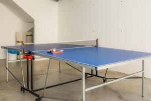 a ping pong table with a ping paddle on it at Villa Can Gaya in Alcudia