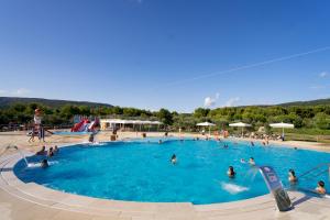a group of people in a swimming pool at Mobile Homes Camping Kovačine in Cres