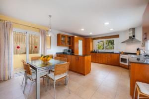 a kitchen with a table and some chairs in it at Villa Can Gaya in Alcudia