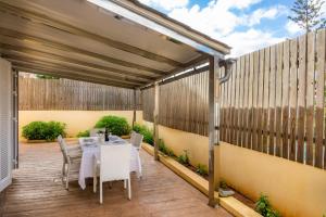 a patio with a table and chairs under a pergola at Villa Can Gaya in Alcudia