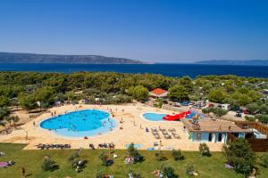an aerial view of a swimming pool at a resort at Mobile Homes Camping Kovačine in Cres
