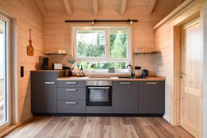 a kitchen in a tiny house at Panoramahisli 3 in Fischerbach +2 photos