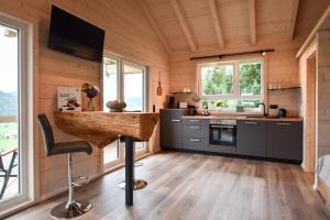 a kitchen with a bar in a tiny house at Panoramahisli 3 in Fischerbach