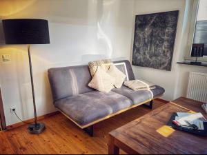 a leather couch with pillows on it in a living room at Ferienwohnung Auszeit in Bad Bertrich