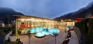 a large building with a swimming pool in front of it at Ferienwohnung Auszeit in Bad Bertrich