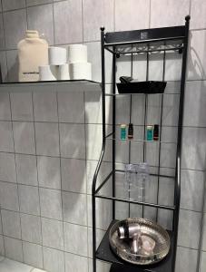 a shelf with cups and a sink in a bathroom at Ferienwohnung Auszeit in Bad Bertrich +20 photos