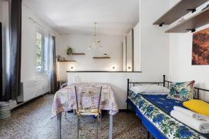 a bedroom with a bed and a table and a tv at Casa Luigi in Vernazza