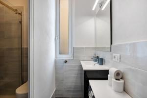 a white bathroom with a sink and a mirror at Casa Luigi in Vernazza