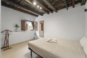 a bedroom with a bed with two towels on it at La Generosa in Arona