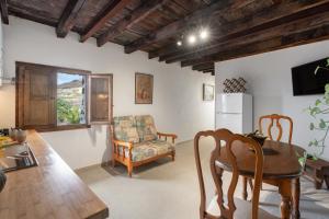 a kitchen and dining room with a table and a chair at La Generosa in Arona