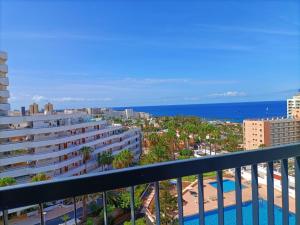 a balcony with a view of the beach and buildings at Casa Marazul in Playa Fañabe